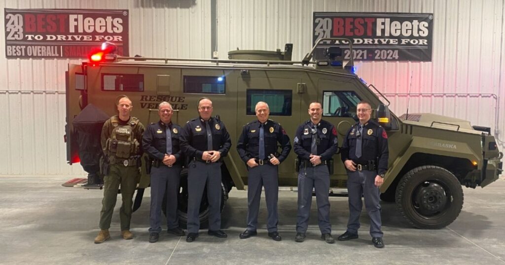 Member of the Nebraska State Patrol standing next to a new BearCats tactical vehicle