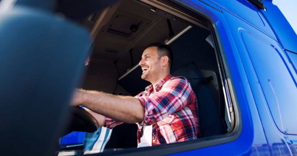 A truck driver behind the wheel of a semi