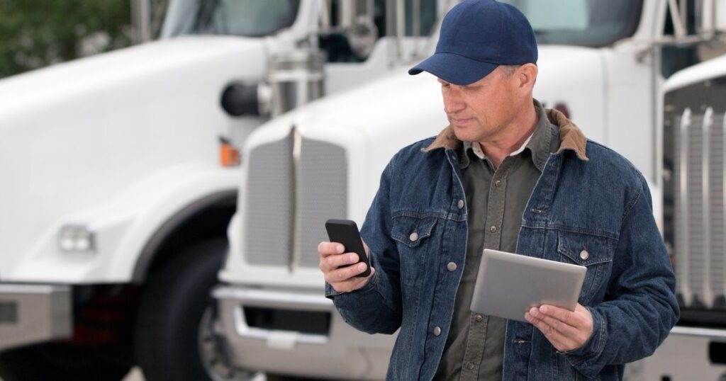 Truck driver checking smartphone